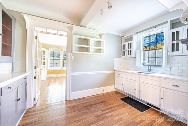 1010 College Ave SW, Lenoir, NC 28645 - kitchen featuring light wood-style flooring, light countertops, white cabinetry, and tasteful backsplash