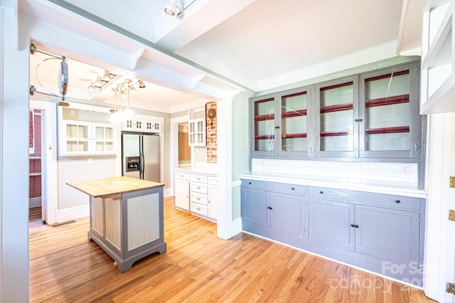 1010 College Ave SW, Lenoir, NC 28645 - kitchen featuring stainless steel fridge with ice dispenser, butcher block countertops, light wood finished floors, glass insert cabinets, and crown molding