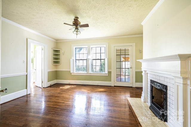 1010 College Ave SW, Lenoir, NC 28645 - unfurnished living room featuring a fireplace, ceiling fan, wood finished floors, a textured ceiling, and crown molding