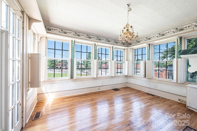 1010 College Ave SW, Lenoir, NC 28645 - unfurnished sunroom featuring wood finished floors and a chandelier
