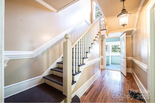1010 College Ave SW, Lenoir, NC 28645 - stairway with crown molding and hardwood / wood-style floors