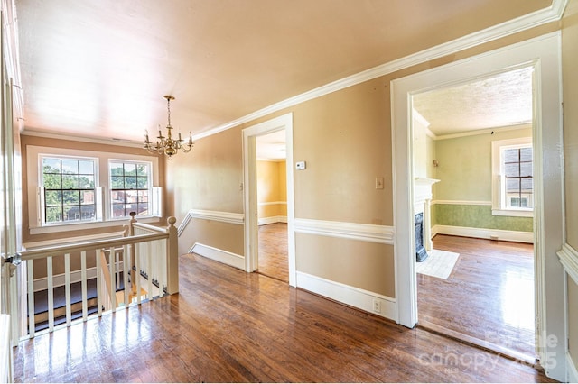 1010 College Ave SW, Lenoir, NC 28645 - empty room with a chandelier, wood finished floors, healthy amount of natural light, and crown molding