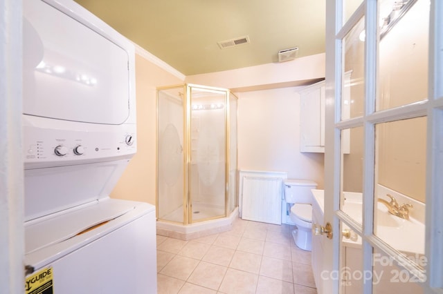 1010 College Ave SW, Lenoir, NC 28645 - full bath featuring estacked washer and dryer, vanity, a shower stall, and tile patterned floors