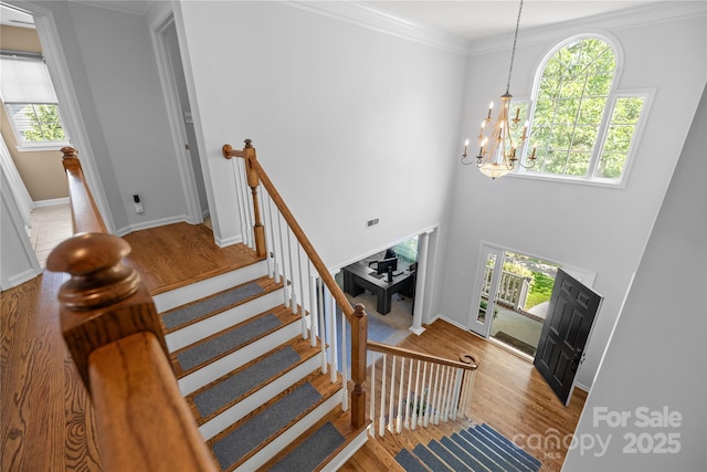 6800 Augustine Way, Charlotte, NC 28270 - staircase with a chandelier, wood finished floors, and crown molding