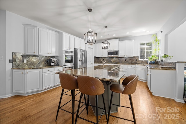6800 Augustine Way, Charlotte, NC 28270 - kitchen with stainless steel appliances, a kitchen breakfast bar, light wood-style flooring, and recessed lighting