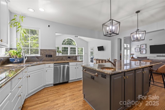 6800 Augustine Way, Charlotte, NC 28270 - kitchen featuring stainless steel dishwasher, open floor plan, a chandelier, white cabinets, and light wood-style flooring