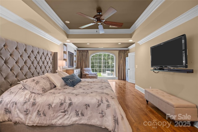 6800 Augustine Way, Charlotte, NC 28270 - bedroom with ornamental molding, a tray ceiling, wood finished floors, and a ceiling fan