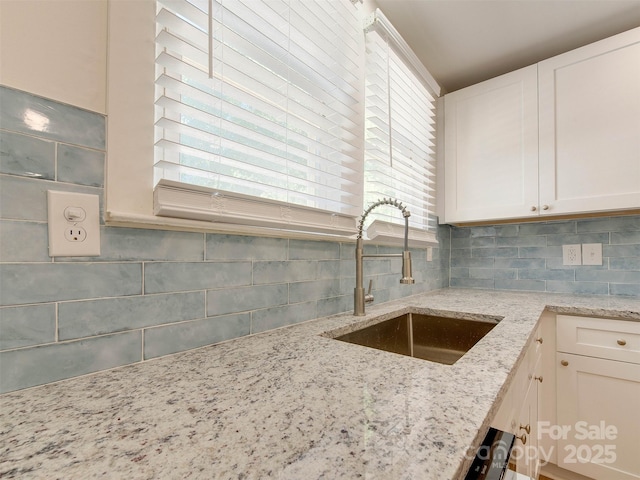 2414 Lane St, Kannapolis, NC 28083 - kitchen with decorative backsplash, white cabinets, light stone countertops, and healthy amount of natural light