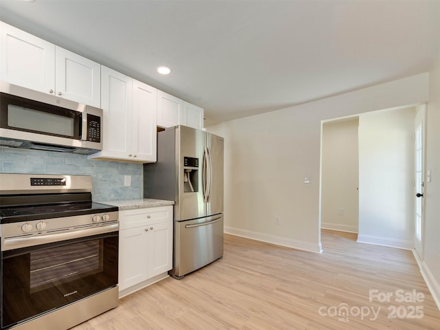 2414 Lane St, Kannapolis, NC 28083 - kitchen featuring stainless steel appliances, tasteful backsplash, light wood-style flooring, white cabinets, and recessed lighting