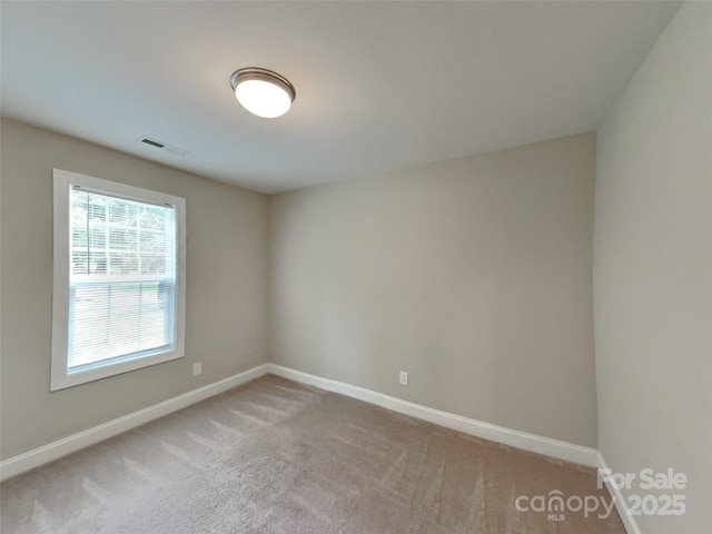 115 Dove Ave SW, Concord, NC 28025 - spare room featuring baseboards and carpet