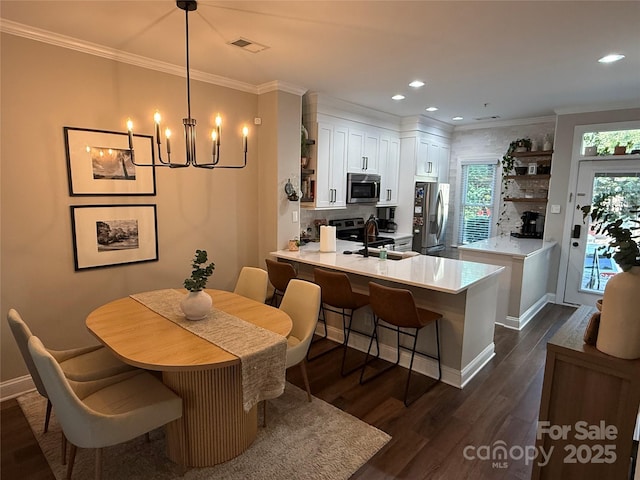 1013 Park W Dr Unit 5, Charlotte, NC 28209 - dining space featuring dark wood-style flooring, a chandelier, crown molding, and recessed lighting