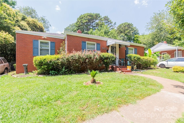 3037 Marlowe Ave, Charlotte, NC 28208 - view of front of property featuring a chimney, a front lawn, and brick siding