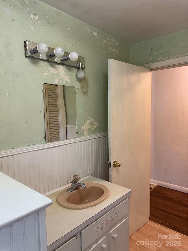 1239 8th St NE, Hickory, NC 28601 - bathroom featuring wood finished floors, a wainscoted wall, and vanity