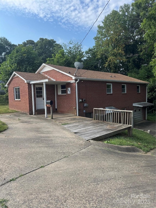 1239 8th St NE, Hickory, NC 28601 - view of front facade featuring brick siding and a wooden deck