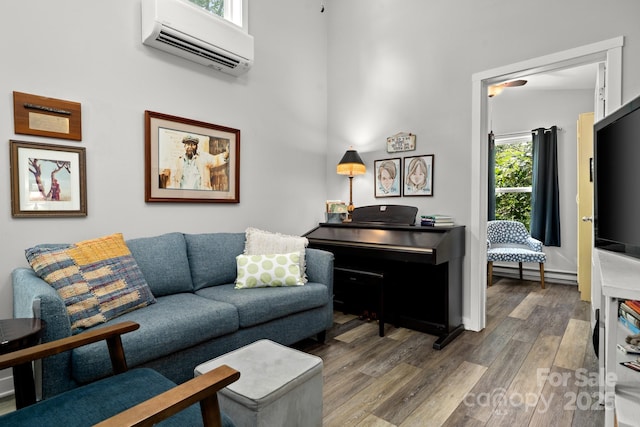211 Summer St, Swannanoa, NC 28778 - living room featuring a wall unit AC, wood finished floors, and a baseboard radiator