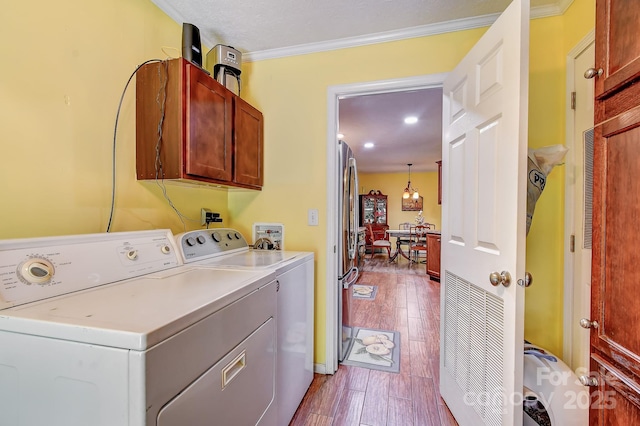 20 Jessica Ln, Barnardsville, NC 28709 - washroom featuring cabinet space, independent washer and dryer, ornamental molding, and dark wood-style flooring
