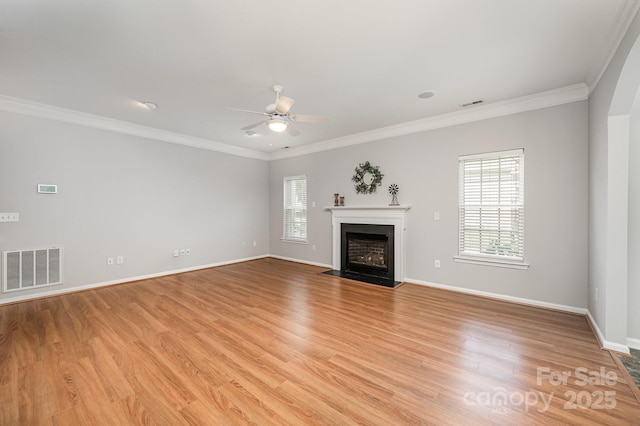 7731 Sedgebrook Dr E, Stanley, NC 28164 - unfurnished living room with ceiling fan, ornamental molding, light wood-type flooring, and a fireplace with flush hearth