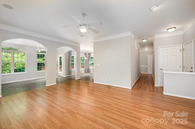 7731 Sedgebrook Dr E, Stanley, NC 28164 - unfurnished living room with ceiling fan, light wood-style floors, ornamental molding, and arched walkways