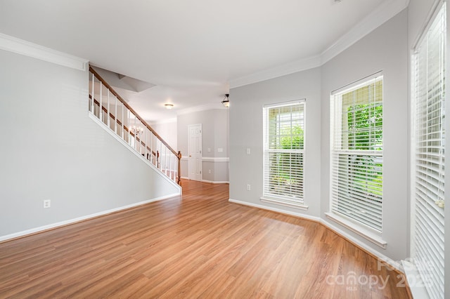 7731 Sedgebrook Dr E, Stanley, NC 28164 - spare room with stairs, crown molding, and light wood-style flooring