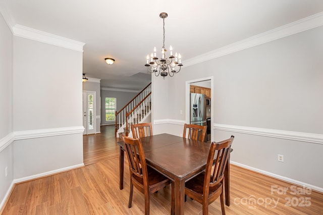 7731 Sedgebrook Dr E, Stanley, NC 28164 - dining area with a chandelier, light wood-type flooring, stairs, and ornamental molding