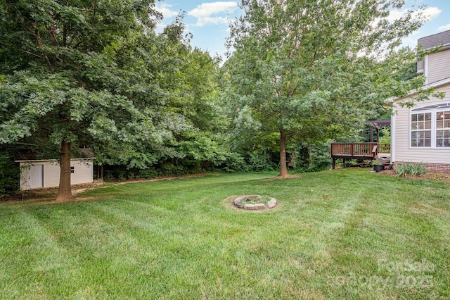 7731 Sedgebrook Dr E, Stanley, NC 28164 - view of grassy yard with a storage shed and a wooden deck