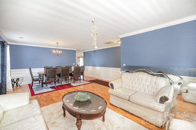 4732 Meadowfield Rd Unit L35, Charlotte, NC 28215 - living area with a chandelier, ornamental molding, a wainscoted wall, and wood finished floors