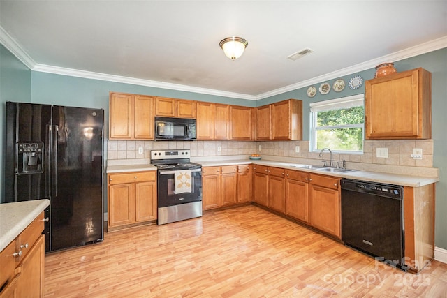 4732 Meadowfield Rd Unit L35, Charlotte, NC 28215 - kitchen with black appliances, light wood-type flooring, light countertops, crown molding, and decorative backsplash