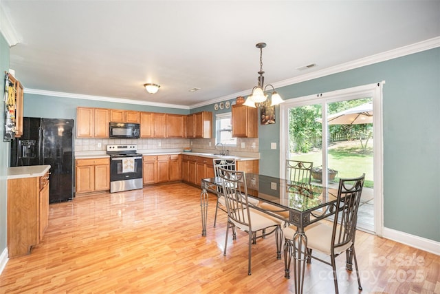 4732 Meadowfield Rd Unit L35, Charlotte, NC 28215 - dining area with light wood-type flooring, crown molding, and a chandelier