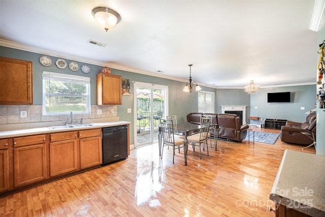 4732 Meadowfield Rd Unit L35, Charlotte, NC 28215 - kitchen featuring dishwasher, brown cabinets, light wood finished floors, light countertops, and a chandelier