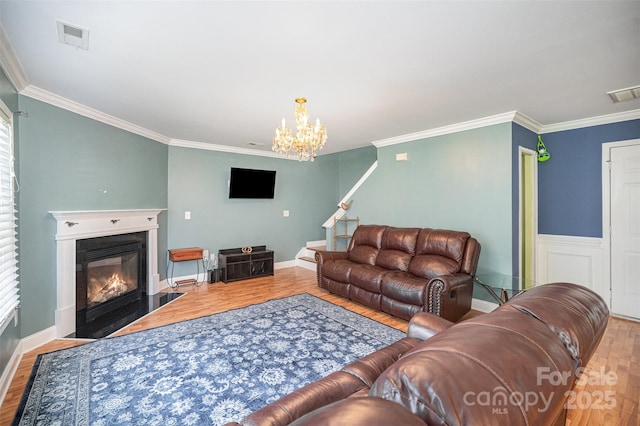 4732 Meadowfield Rd Unit L35, Charlotte, NC 28215 - living area with wood finished floors, ornamental molding, a fireplace with flush hearth, a chandelier, and stairway
