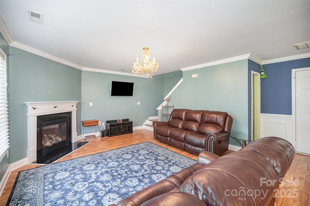 4732 Meadowfield Rd Unit L35, Charlotte, NC 28215 - living area with wood finished floors, ornamental molding, a fireplace with flush hearth, a chandelier, and stairway