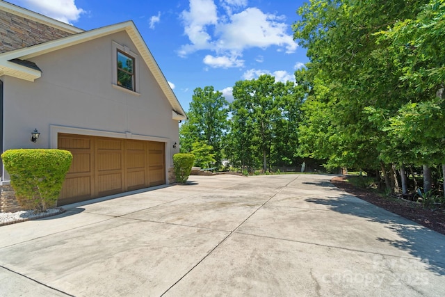 313 Sunset View Ct, York, SC 29745 - view of side of property with stucco siding, concrete driveway, and an attached garage