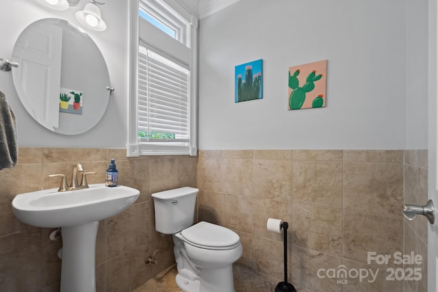313 Sunset View Ct, York, SC 29745 - half bathroom featuring healthy amount of natural light, tile walls, wainscoting, and crown molding