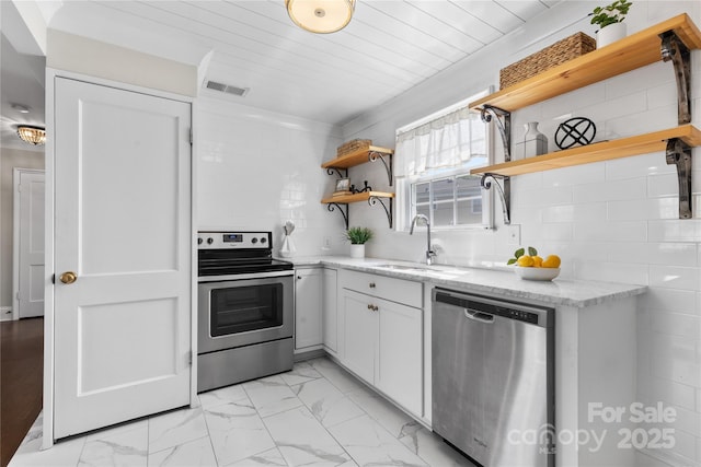 404 Wakefield Dr Unit C, Charlotte, NC 28209 - kitchen featuring stainless steel appliances, open shelves, light marble finish floors, light stone countertops, and white cabinets