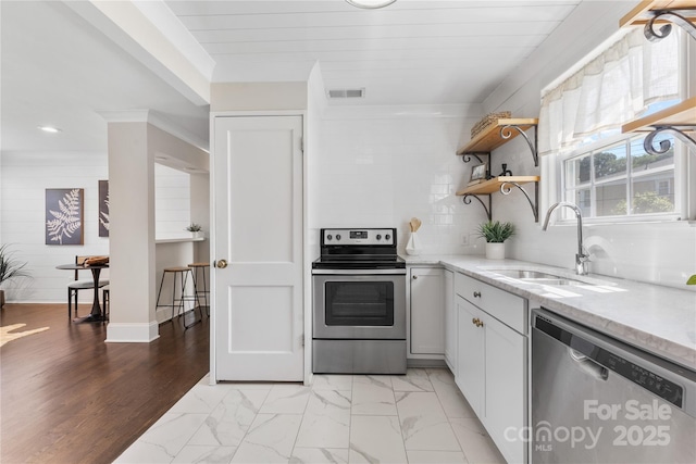 404 Wakefield Dr Unit C, Charlotte, NC 28209 - kitchen with stainless steel appliances, light marble finish flooring, backsplash, light stone countertops, and white cabinets