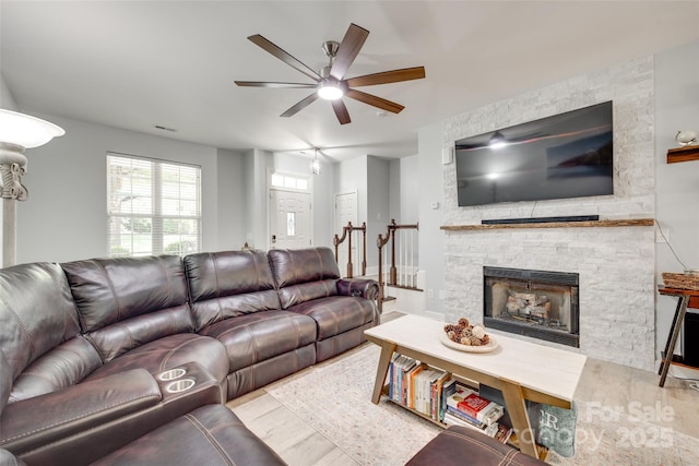 713 Torrey Pines Ln, Fort Mill, SC 29715 - living room with ceiling fan, a stone fireplace, and wood finished floors