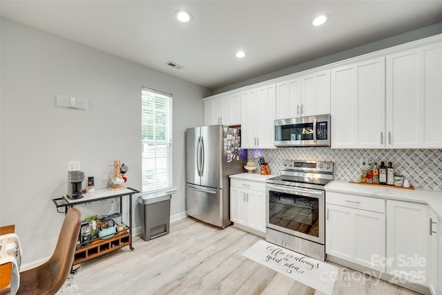 713 Torrey Pines Ln, Fort Mill, SC 29715 - kitchen with stainless steel appliances, tasteful backsplash, white cabinetry, and recessed lighting