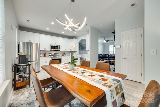 713 Torrey Pines Ln, Fort Mill, SC 29715 - dining room with light wood finished floors, a chandelier, ceiling fan, and recessed lighting