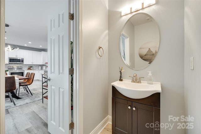713 Torrey Pines Ln, Fort Mill, SC 29715 - bathroom featuring vanity, decorative backsplash, and recessed lighting