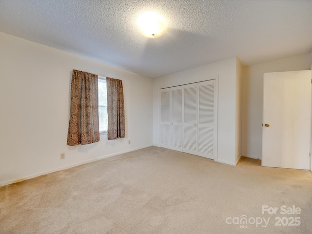 3113 Old Pageland Marshville Rd, Wingate, NC 28174 - unfurnished bedroom with light carpet, a closet, and a textured ceiling