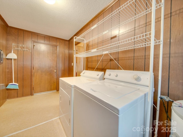3113 Old Pageland Marshville Rd, Wingate, NC 28174 - laundry area featuring separate washer and dryer, wood walls, and a textured ceiling