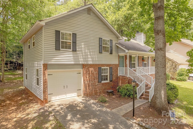 6418 Tivoli Ct, Charlotte, NC 28211 - split level home with brick siding, an attached garage, driveway, a porch, and a chimney