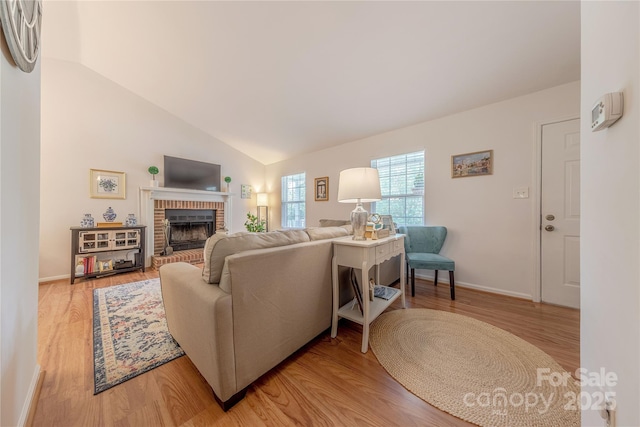 6418 Tivoli Ct, Charlotte, NC 28211 - living room with a brick fireplace, vaulted ceiling, and light wood-type flooring