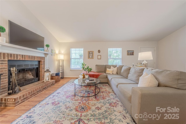 6418 Tivoli Ct, Charlotte, NC 28211 - living room with light wood-style floors, lofted ceiling, and a fireplace