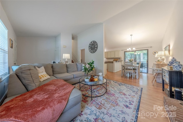 6418 Tivoli Ct, Charlotte, NC 28211 - living room featuring a chandelier, light wood finished floors, vaulted ceiling, and stairway