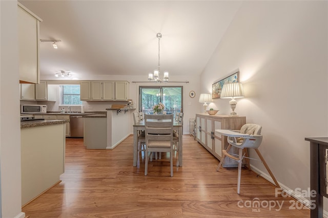 6418 Tivoli Ct, Charlotte, NC 28211 - dining room featuring a chandelier, light wood-style floors, and lofted ceiling