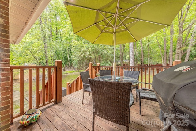 6418 Tivoli Ct, Charlotte, NC 28211 - wooden deck featuring a grill, outdoor dining space, and a view of trees