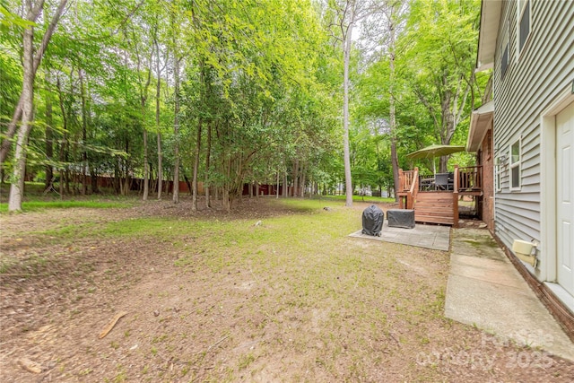 6418 Tivoli Ct, Charlotte, NC 28211 - view of green lawn with a wooden deck, view of scattered trees, and a patio area