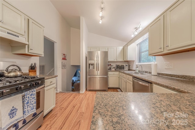6418 Tivoli Ct, Charlotte, NC 28211 - kitchen with appliances with stainless steel finishes, vaulted ceiling, light wood finished floors, and under cabinet range hood