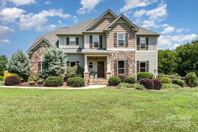 7805 Crooked Creek Church Rd, Monroe, NC 28110 - craftsman inspired home with stone siding, a front yard, and board and batten siding